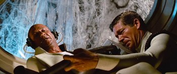 Movie still from “Fantastic Voyage” (1966), directed by Richard Fleischer – A man cutting something with a pair of scissors; Medium shot, Low angle