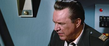 Movie still from “Fantastic Voyage” (1966), directed by Richard Fleischer – A person wearing a suit and tie; Close Up shot, Low angle