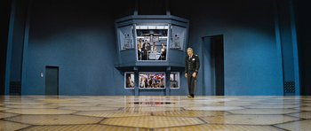 Movie still from “Fantastic Voyage” (1966), directed by Richard Fleischer – A man standing in front of an elevator with a bunch of people; Extreme Wide shot, High angle