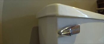 Movie still from “Fart: A Documentary” (2016), directed by Troy Hale – View of a white toilet bowl; Extreme Close Up shot, Low angle