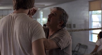Movie still from “Fat City” (1972), directed by John Huston – An older man and a younger man fighting in a room; Close Up shot, Over the shoulder angle