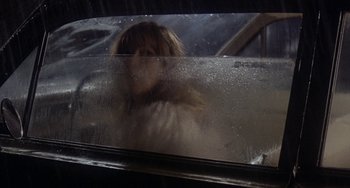 Movie still from “Fat City” (1972), directed by John Huston – A woman standing in front of a window; Close Up shot, Over the shoulder angle