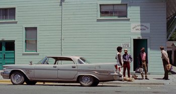 Movie still from “Fat City” (1972), directed by John Huston – Two men standing on the side of the road next to an old car; Wide shot, Low angle