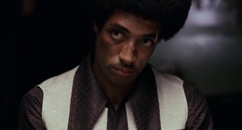 Movie still from “Fat City” (1972), directed by John Huston – A person wearing a suit and tie; Close Up shot, Low angle