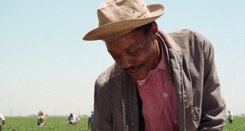 Movie still from “Fat City” (1972), directed by John Huston – An older man wearing a hat and a jacket; Medium shot, Low angle