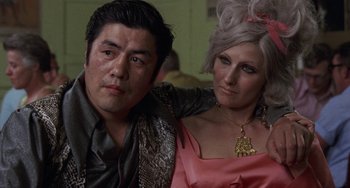 Movie still from “Fat City” (1972), directed by John Huston – A man and a woman pose for a picture; Close Up shot, Low angle