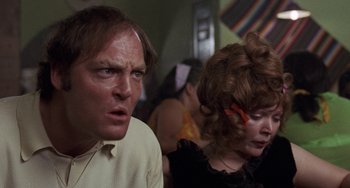 Movie still from “Fat City” (1972), directed by John Huston – A man and a woman are looking at the camera; Close Up shot, Low angle