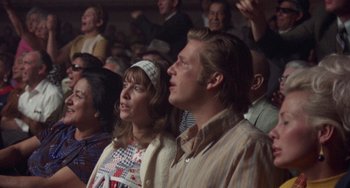 Movie still from “Fat City” (1972), directed by John Huston – A man and a woman are watching a concert; Medium shot, Low angle