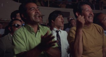 Movie still from “Fat City” (1972), directed by John Huston – A group of men standing in front of each other; Medium shot, Low angle