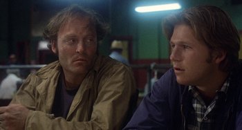 Movie still from “Fat City” (1972), directed by John Huston – Two men sitting next to each other in a room; Close Up shot, Low angle