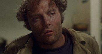 Movie still from “Fat City” (1972), directed by John Huston – A person with a beard; Close Up shot, Low angle