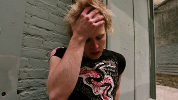 Movie still from “Father's Day” (2011), directed by Conor Sweeney – A person with their hands on their head; Close Up shot, Overhead angle
