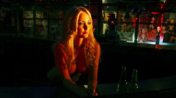 Movie still from “Father's Day” (2011), directed by Conor Sweeney – A beautiful blonde woman sitting at a table; Close Up shot, Low angle