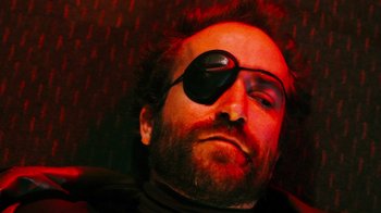 Movie still from “Father's Day” (2011), directed by Conor Sweeney – A person wearing a eye patch; Extreme Close Up shot, Overhead angle