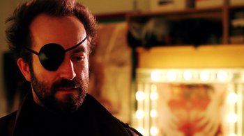 Movie still from “Father's Day” (2011), directed by Conor Sweeney – A person wearing a eye patch; Close Up shot, Over the shoulder angle