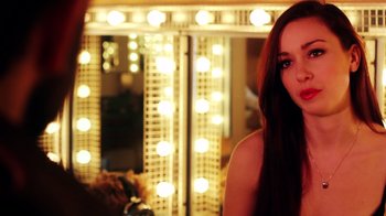 Movie still from “Father's Day” (2011), directed by Conor Sweeney – A beautiful young lady standing in front of a mirror; Close Up shot, Over the shoulder angle