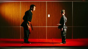 Movie still from “Father's Day” (2011), directed by Conor Sweeney – Two men are facing each other on a red carpet; Wide shot, Over the shoulder angle