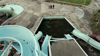 Movie still from “Father's Day” (2011), directed by Conor Sweeney – Three people standing in front of an old airplane; Extreme Wide shot, High angle