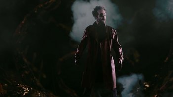 Movie still from “Father's Day” (2011), directed by Conor Sweeney – A man with a beard and sunglasses in a red coat; Medium shot, Low angle