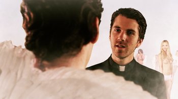 Movie still from “Father's Day” (2011), directed by Conor Sweeney – A man wearing a priest's outfit looking at himself in the mirror; Close Up shot, Over the shoulder angle
