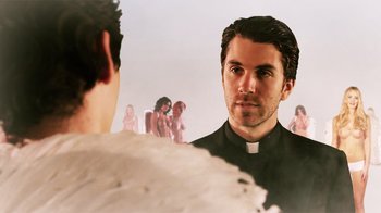 A man wearing a priest's outfit looking into a mirror