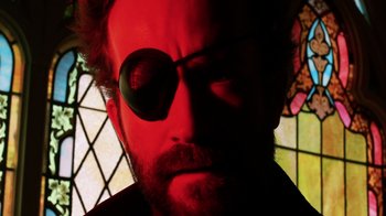 Movie still from “Father's Day” (2011), directed by Conor Sweeney – A person wearing a pair of sunglasses; Extreme Close Up shot, Low angle