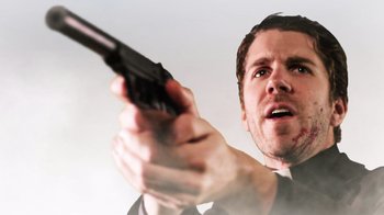 Movie still from “Father's Day” (2011), directed by Conor Sweeney – A person holding a gun in his hand; Close Up shot, Low angle