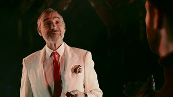 Movie still from “Father's Day” (2011), directed by Conor Sweeney – An older man wearing a white suit and red tie; Close Up shot, Low angle