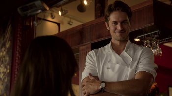 Movie still from “Emily in Paris” (2020), created by Darren Star – A man in a white shirt and a woman in a white shirt; Close Up shot, Over the shoulder angle