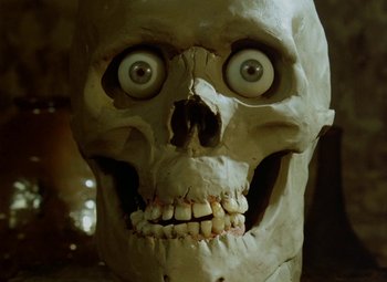 Movie still from “Faust” (1994), directed by Jan Svankmajer – A human skull with eyes wide open; Extreme Close Up shot, Low angle