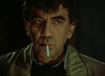 Movie still from “Faust” (1994), directed by Jan Svankmajer – A person with a cigarette in his mouth; Close Up shot, Low angle