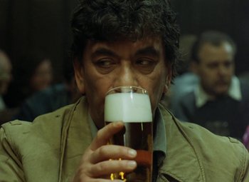 Movie still from “Faust” (1994), directed by Jan Svankmajer – A person holding a glass of beer; Close Up shot, Over the shoulder angle