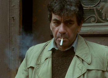 Movie still from “Faust” (1994), directed by Jan Svankmajer – A person smoking a cigarette outside; Close Up shot, High angle
