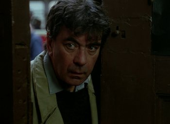 Movie still from “Faust” (1994), directed by Jan Svankmajer – A person looking at the camera; Close Up shot, Over the shoulder angle