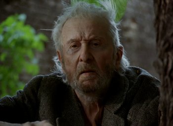 Movie still from “Faust” (1994), directed by Jan Svankmajer – An old man with white hair is looking at the camera; Close Up shot, Low angle