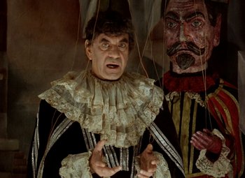 Movie still from “Faust” (1994), directed by Jan Svankmajer – A man dressed as a clown and a man dressed as a jester; Medium shot, Low angle