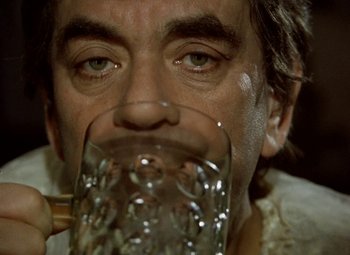 Movie still from “Faust” (1994), directed by Jan Svankmajer – A person drinking a glass of water; Extreme Close Up shot, Low angle