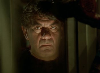 Movie still from “Faust” (1994), directed by Jan Svankmajer – A person looking at the camera; Close Up shot, Low angle