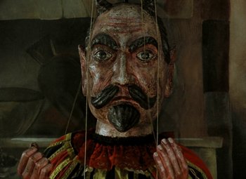 Movie still from “Faust” (1994), directed by Jan Svankmajer – The face of a wooden puppet; Extreme Close Up shot, Overhead angle