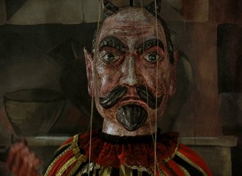 Movie still from “Faust” (1994), directed by Jan Svankmajer – The face of a wooden marionette; Extreme Close Up shot, Overhead angle