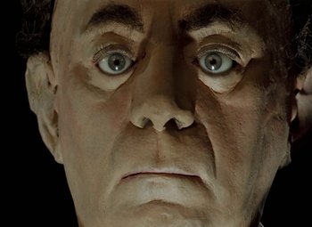 Movie still from “Faust” (1994), directed by Jan Svankmajer – The face of a man with blue eyes; Extreme Close Up shot, Overhead angle