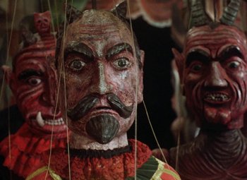 Movie still from “Faust” (1994), directed by Jan Svankmajer – A person wearing a mask; Close Up shot, Overhead angle