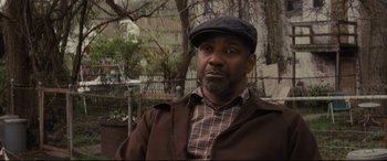 Movie still from “Fences” (2016), directed by Denzel Washington – A man wearing a hat and a brown jacket; Close Up shot, Over the shoulder angle