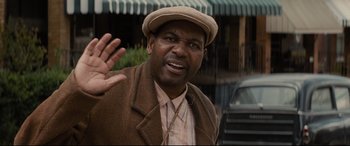 Movie still from “Fences” (2016), directed by Denzel Washington – A man wearing a hat and a brown jacket; Close Up shot, Over the shoulder angle