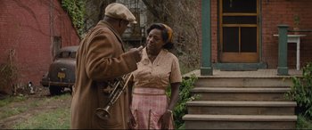 Movie still from “Fences” (2016), directed by Denzel Washington – An older man and woman standing next to each other; Medium shot, Over the shoulder angle