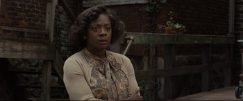 Movie still from “Fences” (2016), directed by Denzel Washington – A woman standing in front of a wooden fence; Close Up shot, Over the shoulder angle