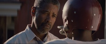 Movie still from “Fences” (2016), directed by Denzel Washington – An older man is looking at a younger man; Close Up shot, Over the shoulder angle