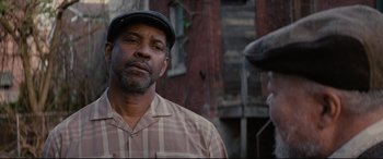 Movie still from “Fences” (2016), directed by Denzel Washington – An older man wearing a hat and a plaid shirt; Close Up shot, Over the shoulder angle