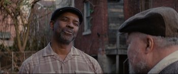 Movie still from “Fences” (2016), directed by Denzel Washington – A person wearing a hat; Close Up shot, Over the shoulder angle