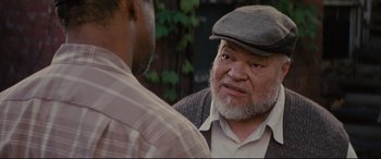 Movie still from “Fences” (2016), directed by Denzel Washington – An older man wearing a hat talking to a younger man; Close Up shot, Over the shoulder angle